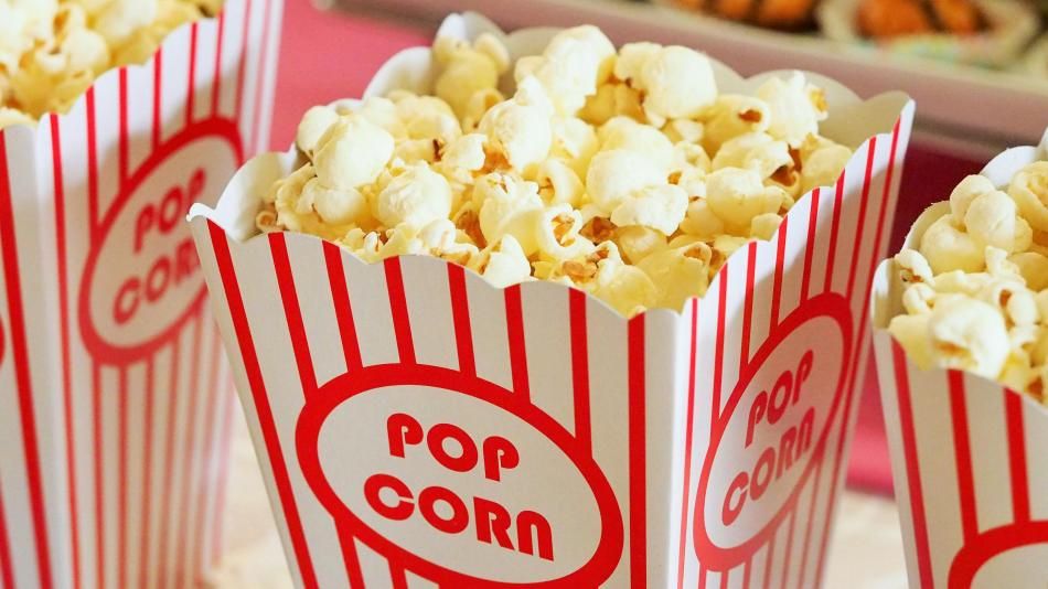 The image is a box of popcorn with the word "POP" on top and "CORO" and "CORN" below. The box likely contains kettle corn or sweet popcorn, and it is a snack or junk food item.