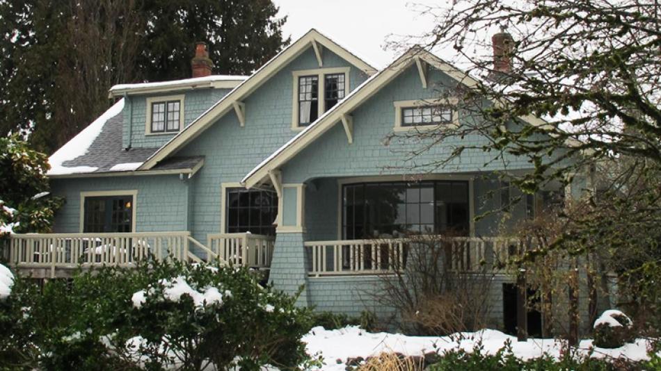 The exterior of the Rush House, including the snow covered shrubs in the front yard.