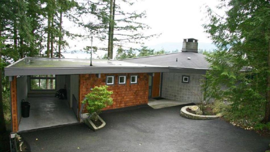 The exterior of the Sykes House, including the driveway and carport.