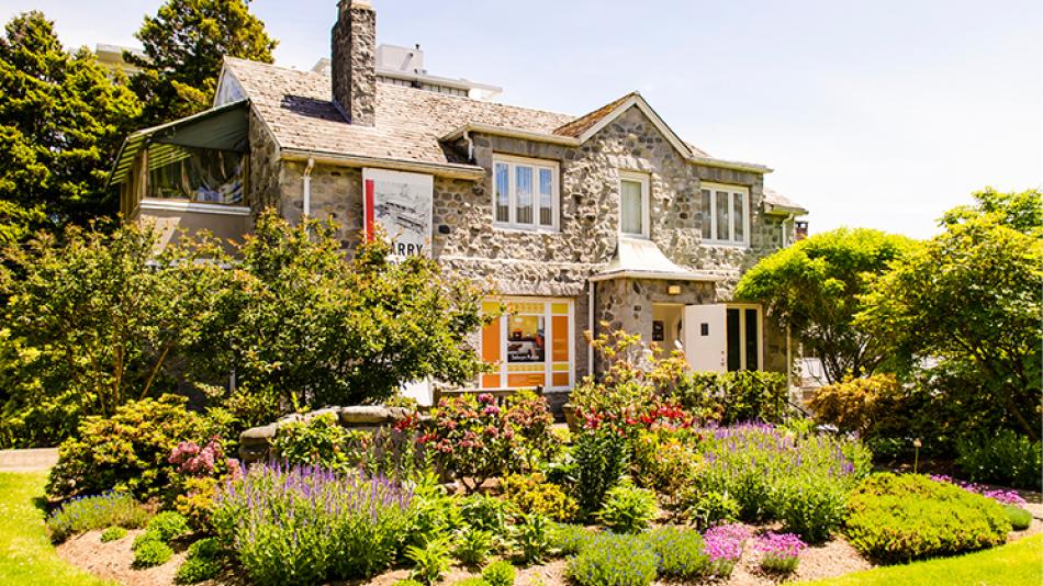 The front of the Gertrude Lawson building, including a large garden.