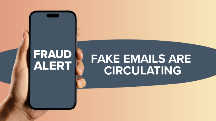 The image displays a modern, graphic presentation of a fraud alert. A hand is holding a dark-colored smartphone in the foreground, positioned slightly to the left of center. The phone's screen is illuminated and shows bold, white text that reads "FRAUD ALERT" stacked in two lines. The phone itself has a sleek, contemporary design with a black bezel and a notch at the top.
