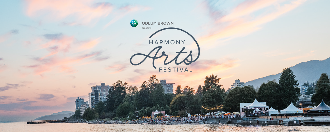 The image is a promotional poster for the "Harmony Arts Festival," presented by Odlum Brown. The scene captures a lively, outdoor event taking place by the water at sunset. There's a crowd of people gathered near the shore, with tents and trees in the background. Tall buildings and mountains add depth to the scenery. The sky is filled with soft, warm colors from the setting sun, creating a welcoming atmosphere.