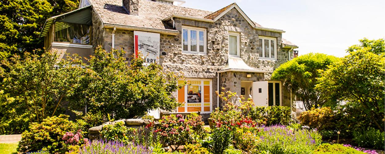 The front of the Gertrude Lawson building, including a large garden.