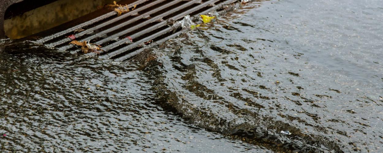 water draining into storm sewer following heavy rain