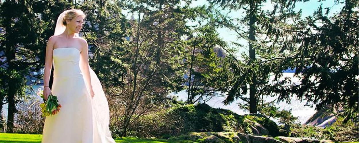 Woman in wedding dress at park