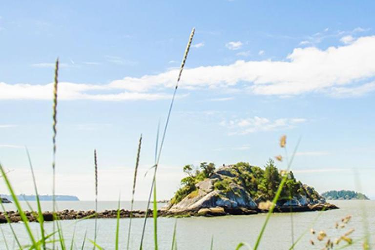 A small rocky peninsula in a small bay.  