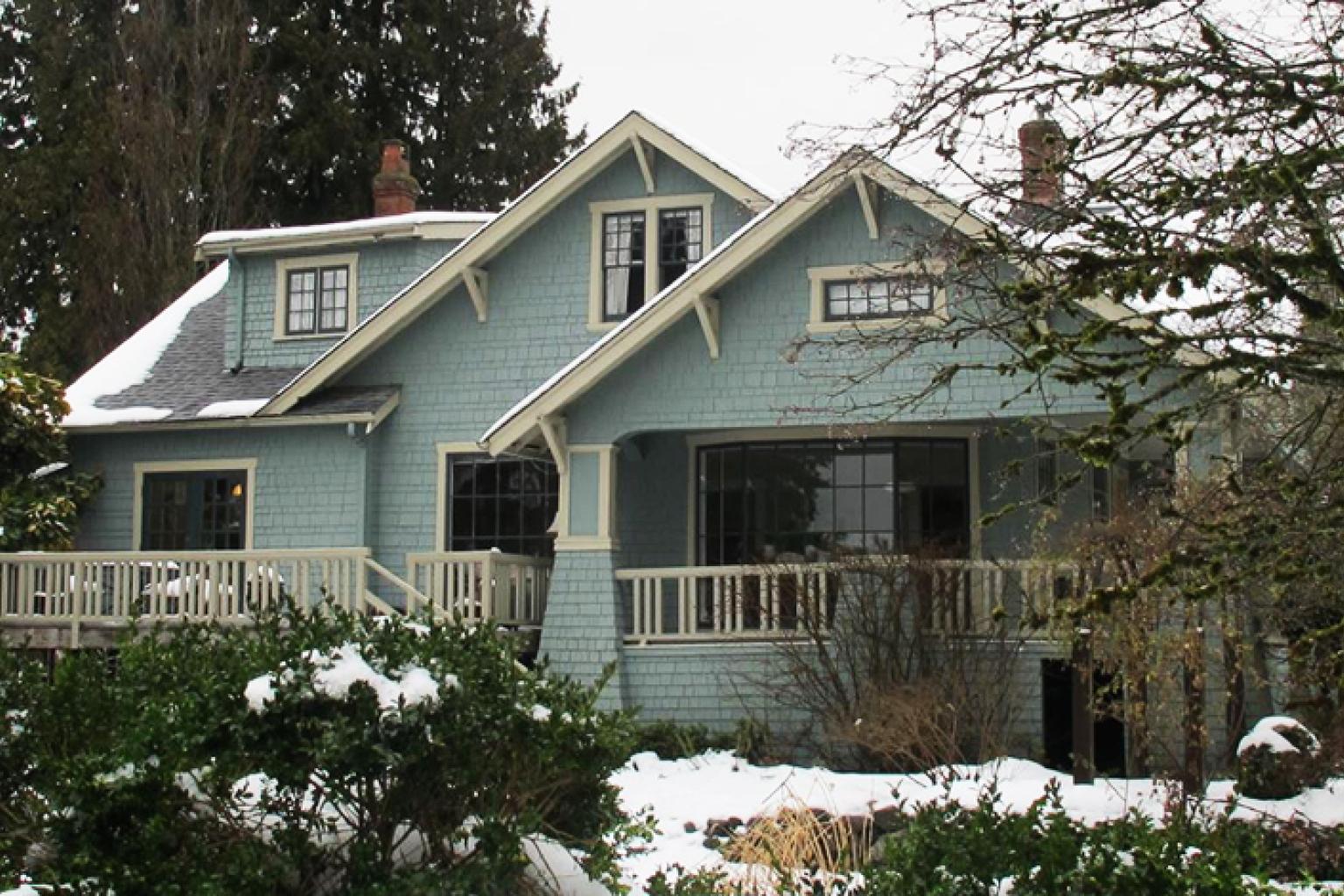 The exterior of the Rush House, including the snow covered shrubs in the front yard.