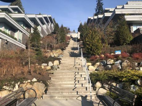 Long staircase leading up a hill with buildings on the sides.